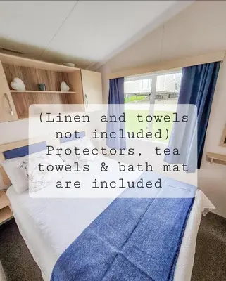 a bedroom with a bed with a sign on it at Summer Breeze in Perranzabuloe