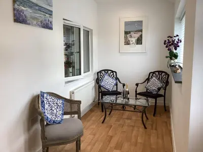 a room with three chairs and a table and a window at Bluebirds villa in Padstow
