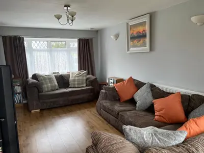 a living room with a couch and a chair at Itldo in Truro