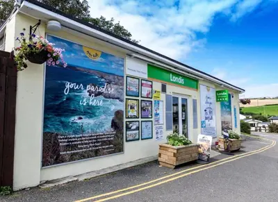 a building with posters on the side of it at Newquay Bay Holiday Resort Caravan 142 in Porth