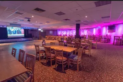 a banquet hall with tables and chairs and pink lighting at Newquay Bay Holiday Resort Caravan 142 in Porth