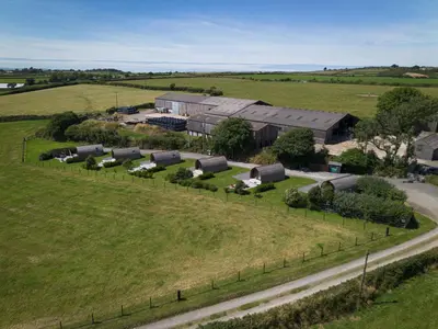 an aerial view of a farm with buildings and a road at Grassington Farm by Wigwam Holidays in Helston
