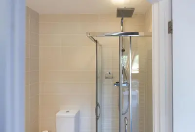a bathroom with a shower and a toilet at The Old Carriage Works in Lostwithiel