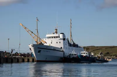 a large ship is docked in the water at Thea Cottage in Perranuthnoe