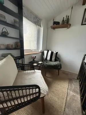 a living room with a couch and a chair at Thea Cottage in Perranuthnoe