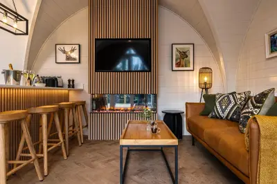 a living room with a couch and a table at POD St Ives - LUXURY GLAMPING ACCOMMODATION in St Ives