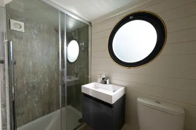 a bathroom with a sink and a shower at POD St Ives - LUXURY GLAMPING ACCOMMODATION in St Ives