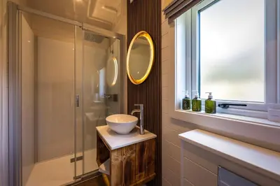 a bathroom with a sink and a glass shower at POD St Ives - LUXURY GLAMPING ACCOMMODATION in St Ives