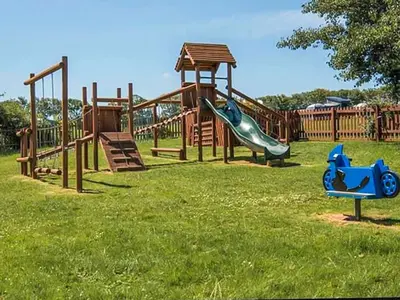 a group of playground equipment in a park at Sandy Toes in Newquay