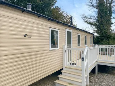 a house with a porch and stairs on it at Sandy Toes in Newquay