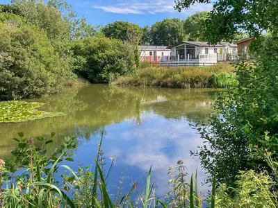 a view of a river with a house in the background at Sandy Toes in Newquay