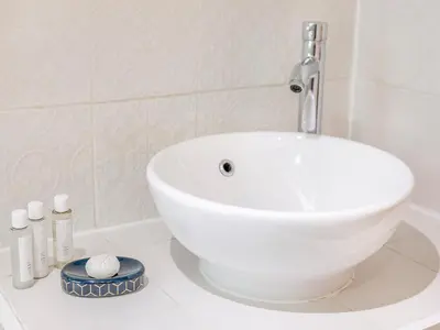 a white sink sitting on a counter in a bathroom at Fishermans Cottage in St Ives