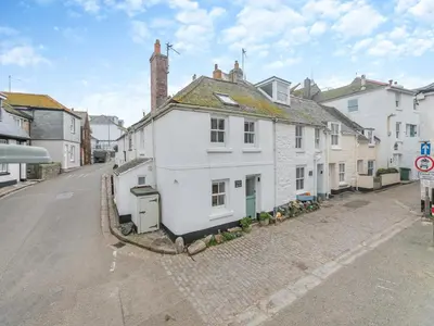 a white house on the side of a street at Fishermans Cottage in St Ives