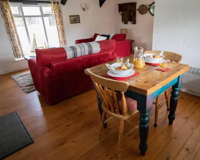 a living room with a table with food on it at Bligh - Treworgie Barton Cottages in Bude