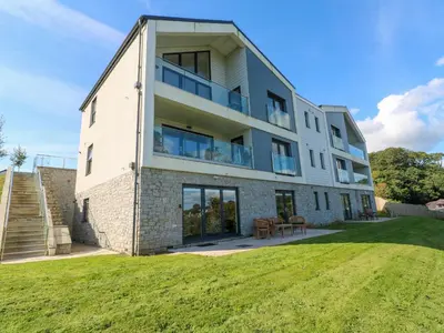 an image of a house with a lawn at 2 The Dunes in Falmouth