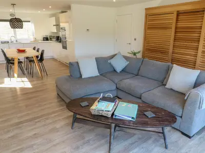 a living room with a couch and a table at 2 The Dunes in Falmouth