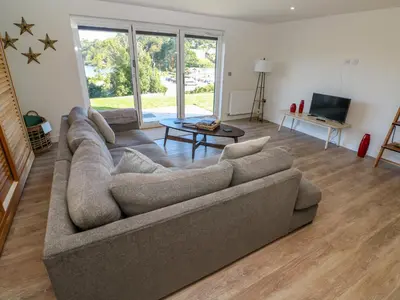 a living room with a couch and a table at 2 The Dunes in Falmouth