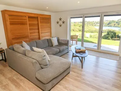 a living room with a couch and a table at 2 The Dunes in Falmouth