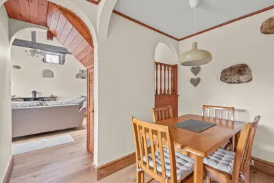 a kitchen and dining room with a wooden table and chairs at The Dairy in Liskeard