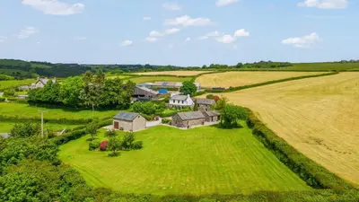 an aerial view of a house in the middle of a field at The Dairy in Liskeard