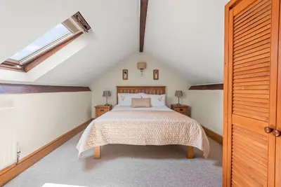a attic bedroom with a bed and a skylight at The Dairy in Liskeard
