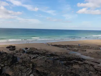a view of the ocean from the rocks on the beach at 33 Tre Lowen in Newquay