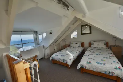 two beds in a room with an attic at Morning Cottage in St Ives