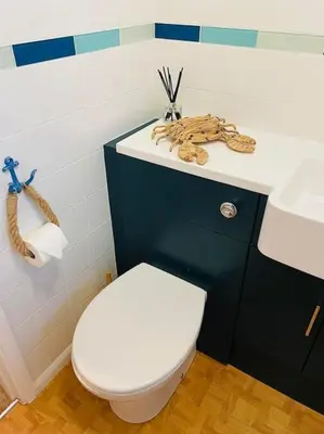 a bathroom with a white toilet and a sink at The Lookout in Carbis Bay