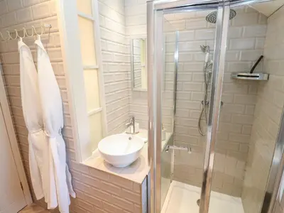 a bathroom with a sink and a shower at Apple Tree Cottage in Helston