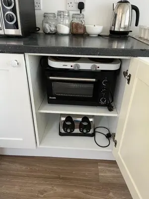 a kitchen with a counter top with a toaster oven at Hellfire corner in Redruth