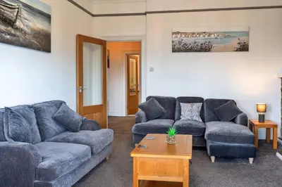 a living room with two couches and a table at Finest Retreats - No 6 Porthgwidden in St Ives