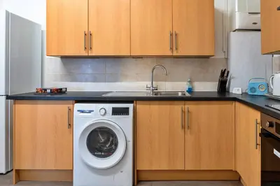 a kitchen with a washing machine and a sink at Finest Retreats - No 6 Porthgwidden in St Ives