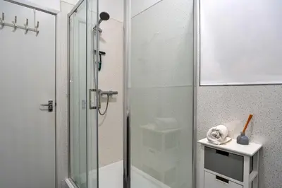 a bathroom with a shower with a glass door at Finest Retreats - No 6 Porthgwidden in St Ives