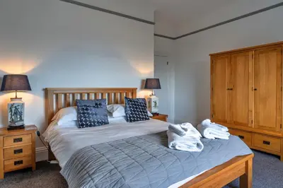 a bedroom with a bed with two pillows on it at Finest Retreats - No 6 Porthgwidden in St Ives