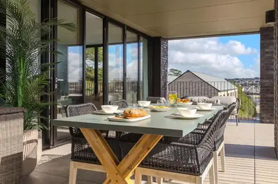 a table with food on it on a balcony at 14 An Garth in Hayle
