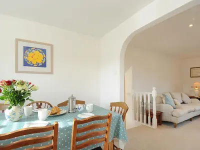 a dining room with a table and a couch at Trestar in Wadebridge