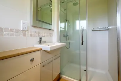 a bathroom with a sink and a shower at Trestar in Wadebridge