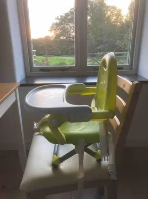 a green chair sitting in front of a window at Little Barn in Bodmin