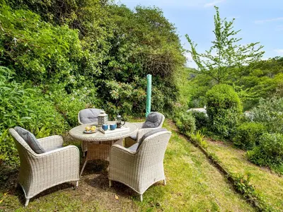 a table and two chairs sitting on a patio at Lynwood in Boscastle