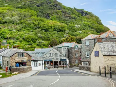 a street in a village with a mountain at Lynwood in Boscastle
