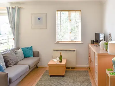 a living room with a couch and a table at Dreckly in Falmouth