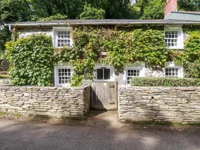 an old stone house with a stone wall at Willow View in Wadebridge