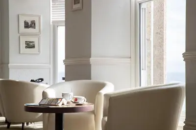 a room with two chairs and a table with a coffeeucer at The St Ives Bay Hotel in St Ives