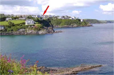 a red arrow pointing to a house on an island in the water at Ocean View, 5 bedrooms sleeps 10, stunning views, parking x4 in Mevagissey