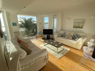 a living room with two couches and a television at Ocean View, 5 bedrooms sleeps 10, stunning views, parking x4 in Mevagissey