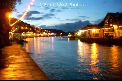 a view of a river at night with lights at The Middleton Beach Lodge in Looe