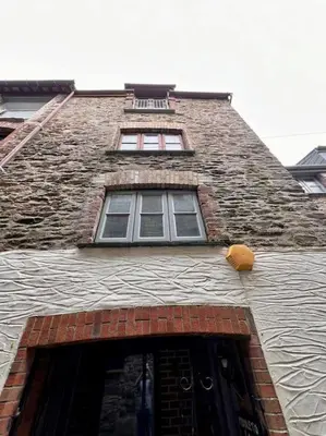 a brick building with a window on top of it at The Middleton Beach Lodge in Looe