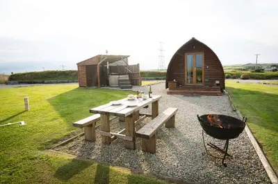 a small cabin with a picnic table and a grill at Great Tregath by Wigwam Holidays in Camelford