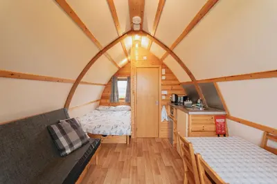 a room with a bed and a desk in a room at Great Tregath by Wigwam Holidays in Camelford