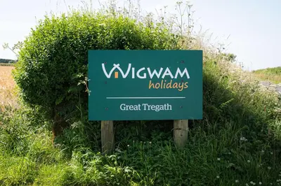 a sign for a wijkun holidays in a field at Great Tregath by Wigwam Holidays in Camelford
